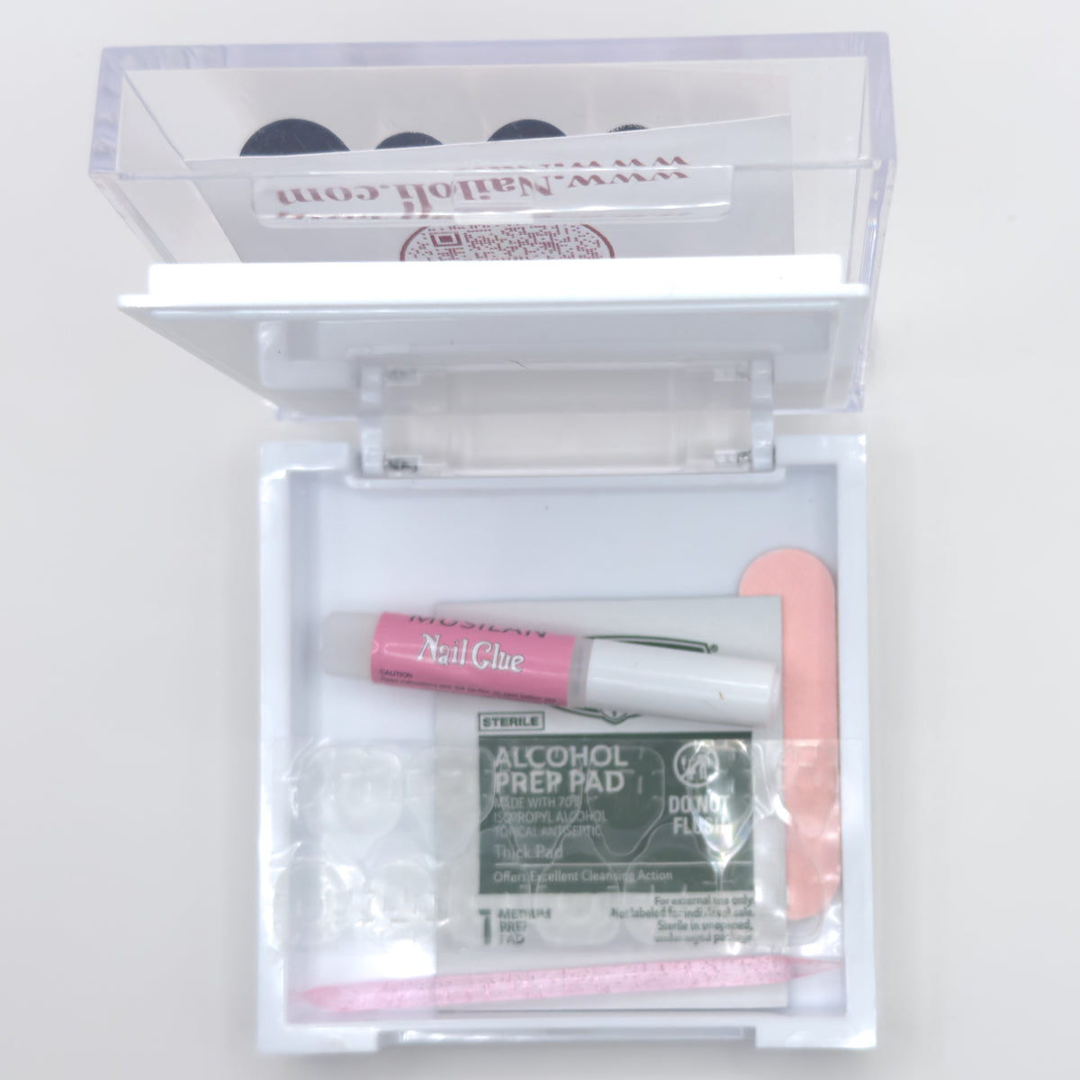 Open Nailoli case with nail glue and a file in the tray and a nailoli.com card in the lid