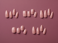 Nude press-on nails in five shapes on a mauve background