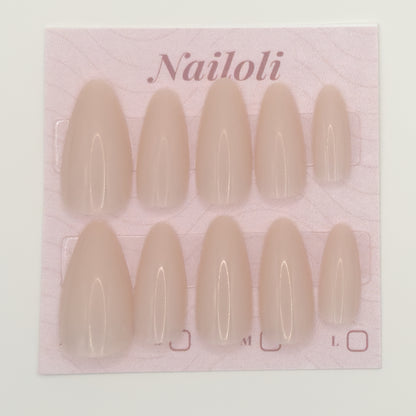 Pack of beige nail extensions with 'Nailoli' branding on a pink background