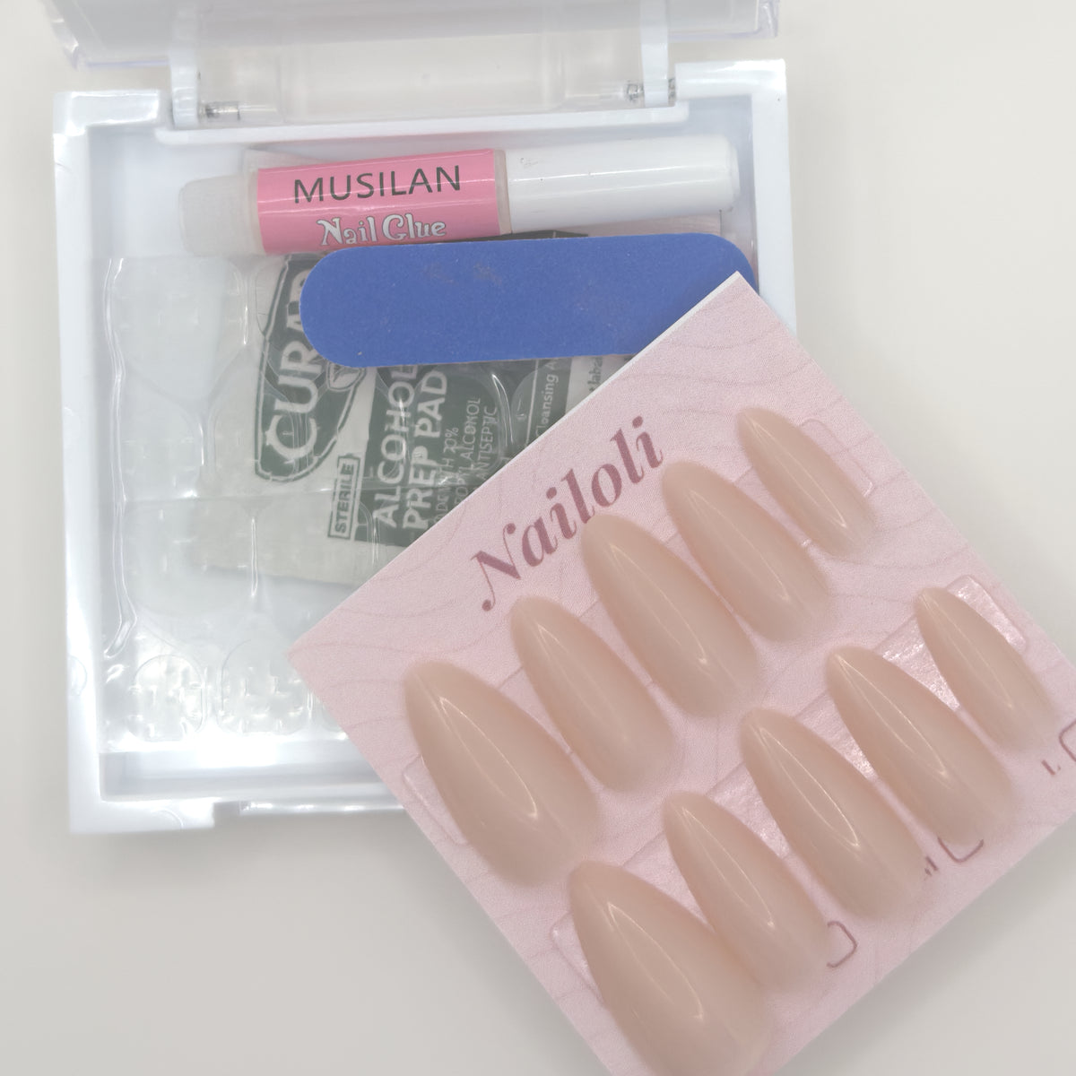 Cashmere nude set on its card beside the open kit with nail glue, nail file, and prep pad