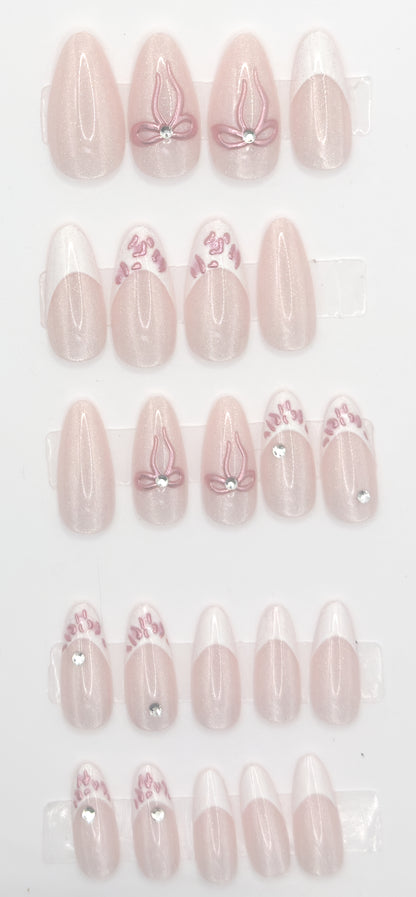 Full ribbon blush almond set laid out in three rows from largest to smallest size