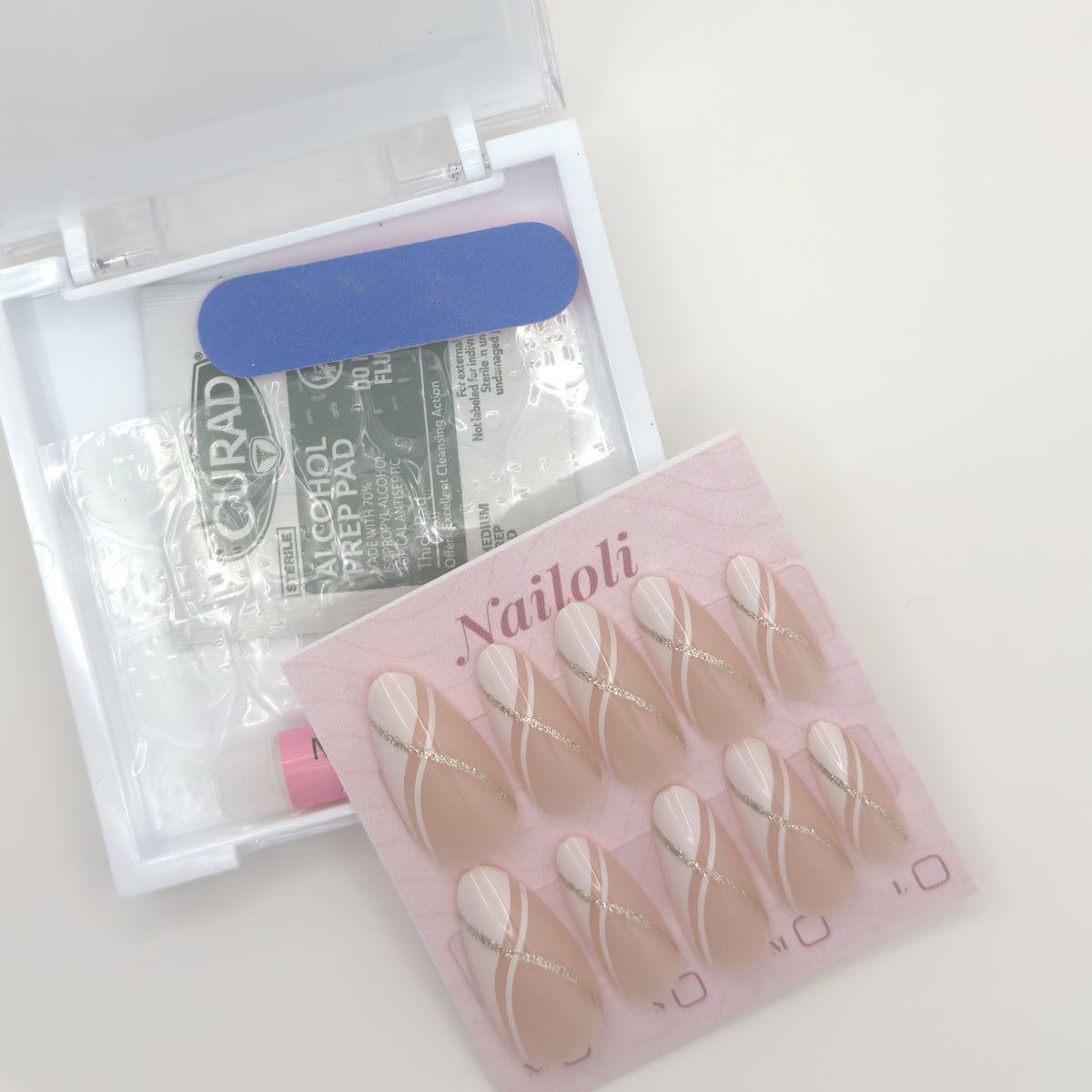 Nail art kit with nailtemplates and alcohol prep pads on a white background