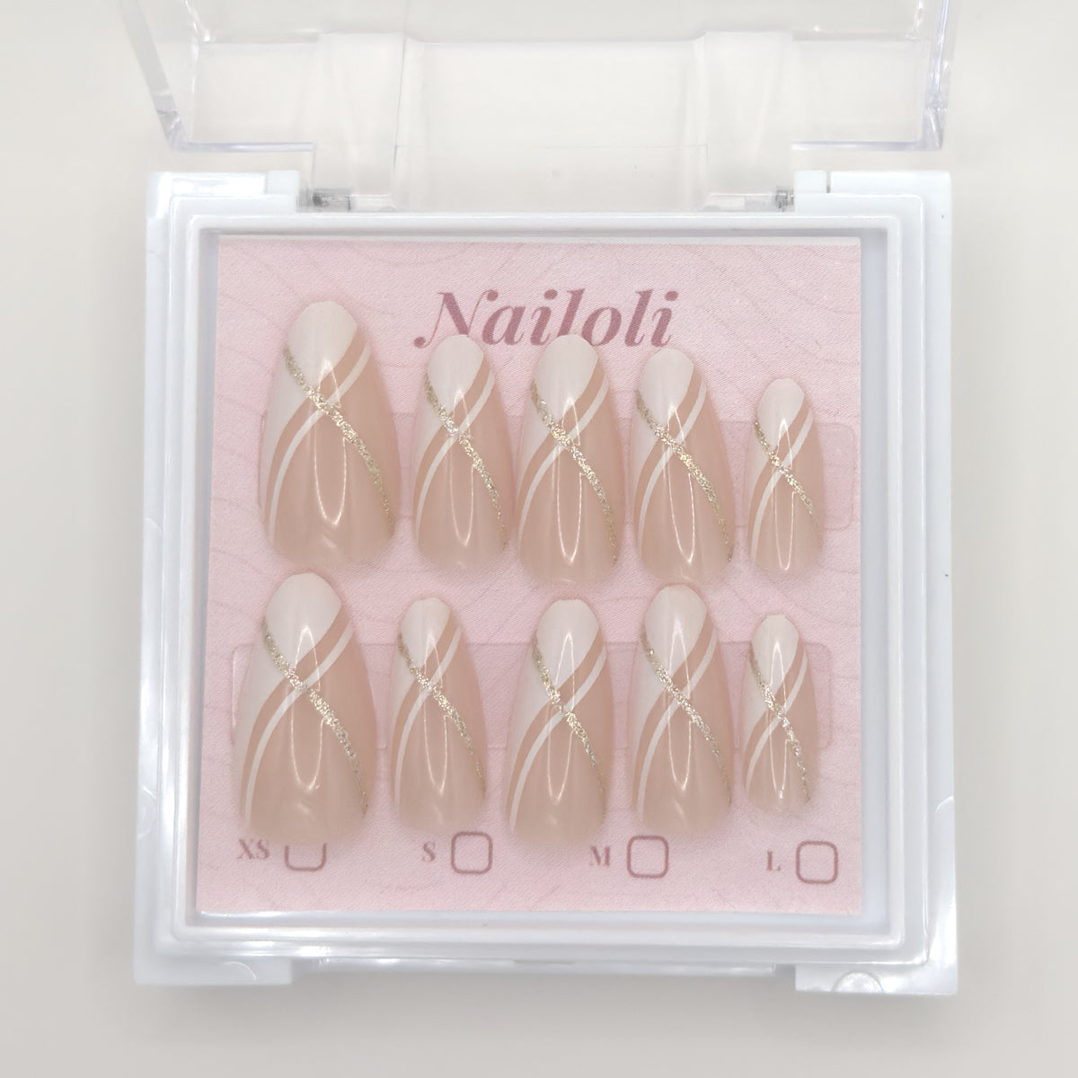 Set of press-on nails with gold accents in a 'Nailoli' box on a light background