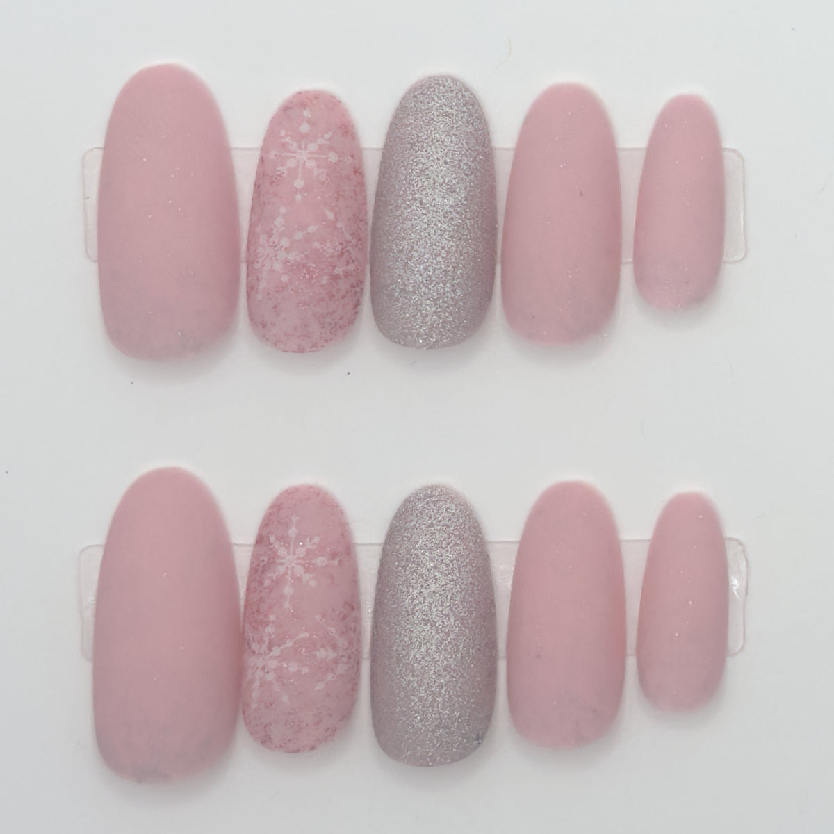 Set of pink and silver glittery nail designs on a white background