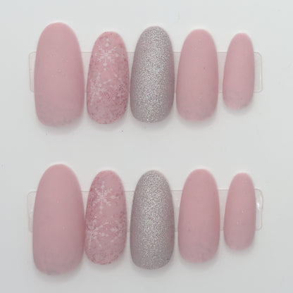 Set of pink and silver glittery nail designs on a white background