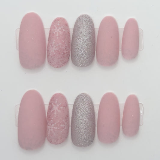 Set of pink and silver glittery nail designs on a white background