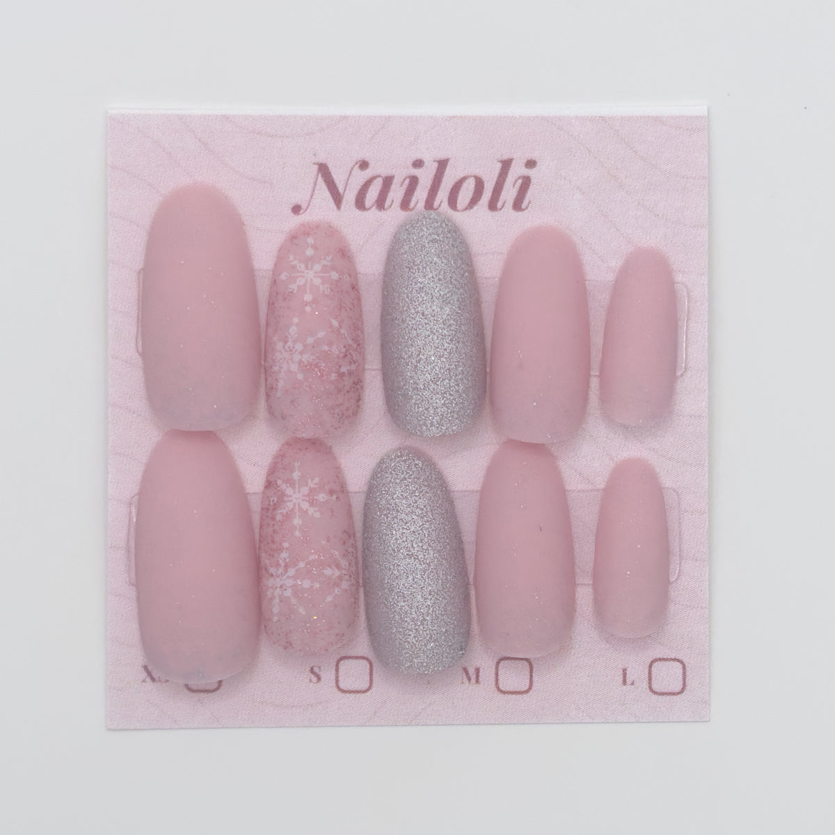 Set of pink and silver nails on a 'Nailoli' branded card.