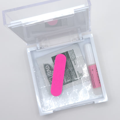 Clear plastic case with pink nail file and small bottle on a white background