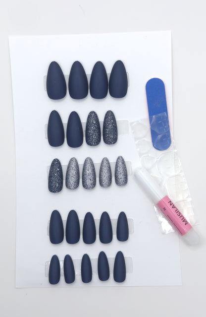 Full midnight navy set beside a nail file and adhesive tabs