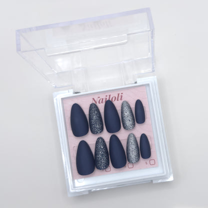 Midnight navy set on its backing card inside the open clear Nailoli case