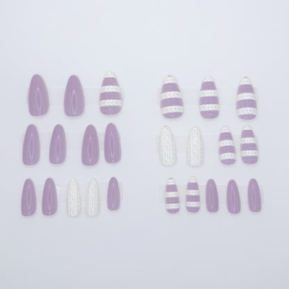 Set of purple and white striped nail art decorations on a light purple background