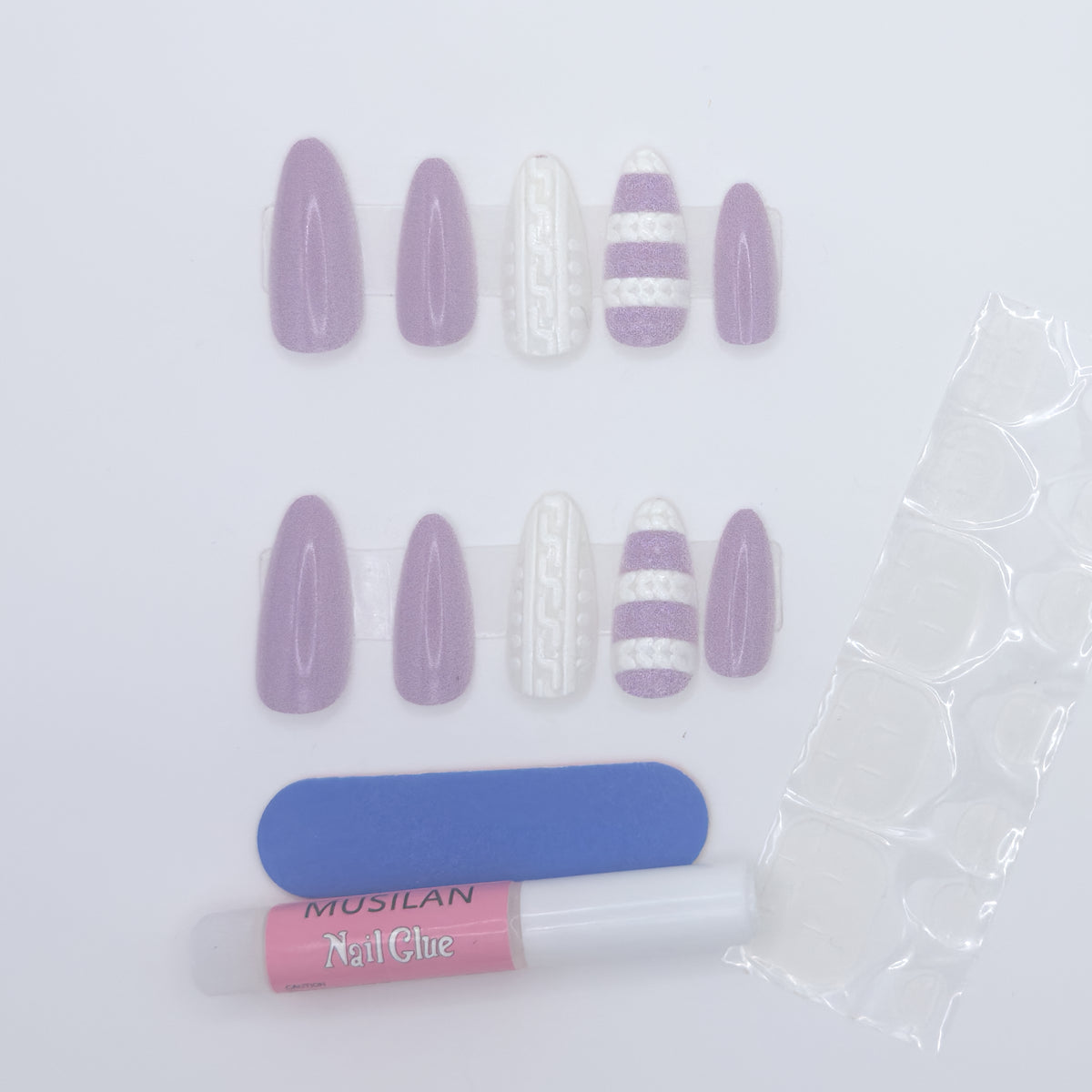 Set of purple and white nail extensions with a bottle of nail glue on a light gray background
