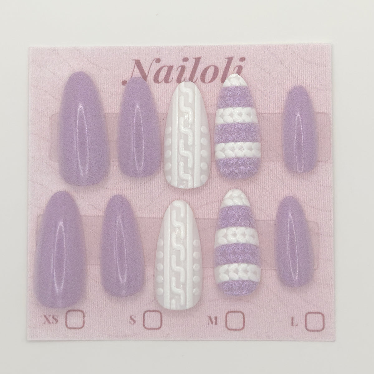 Set of purple and white nail extensions on a pink 'Nailoli' branded card.