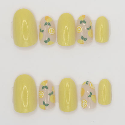 Set of yellow nail wraps with lemon designs on a white background