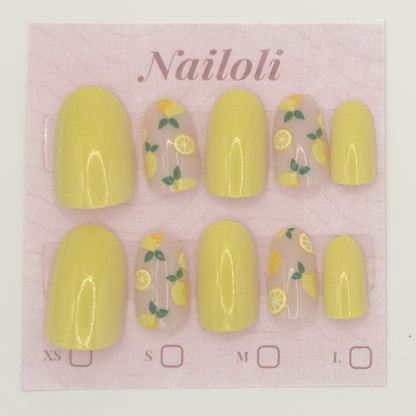 Yellow nail polish set with lemon design on a pink 'Nailoli' branded card.