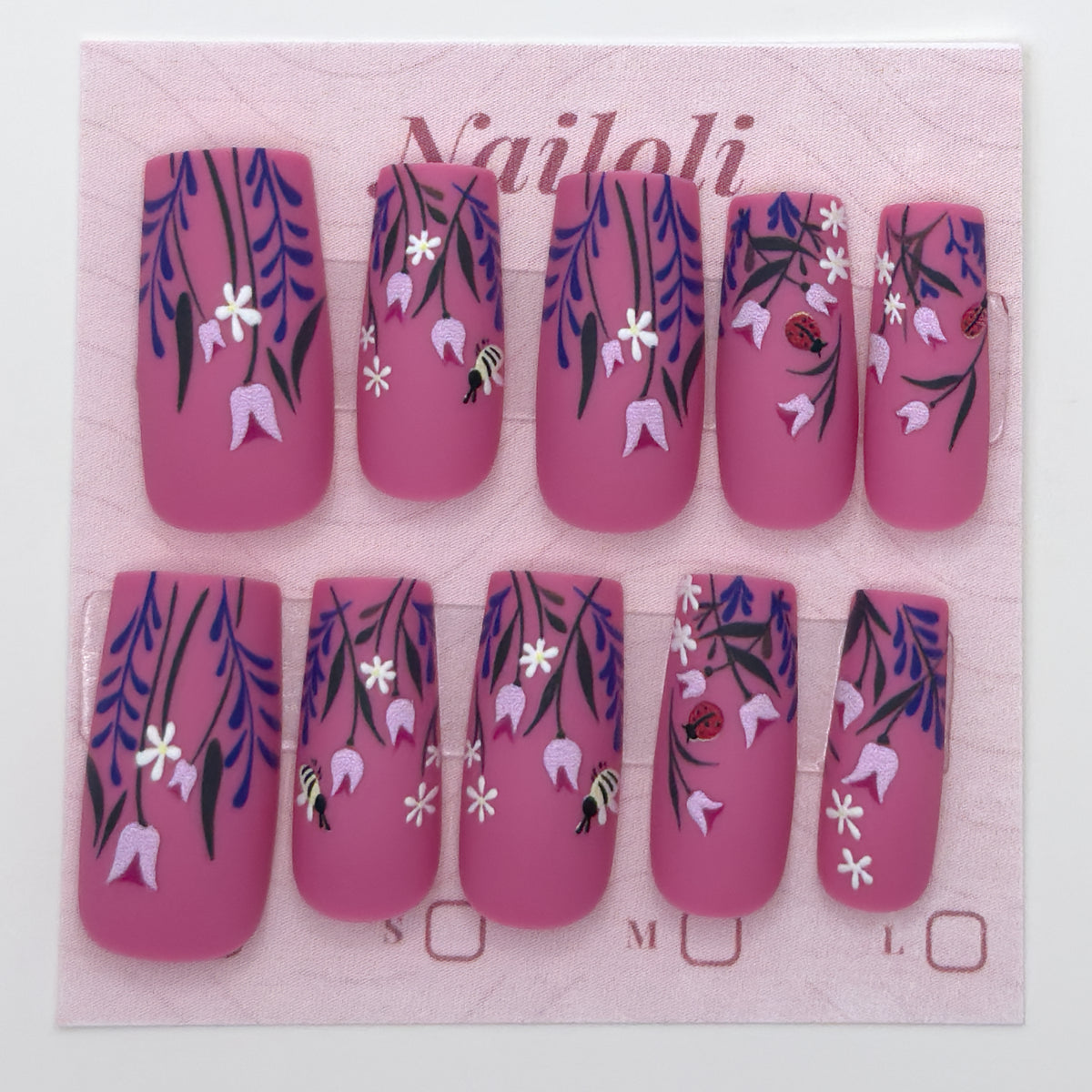Magenta botanical nails on the pink Nailoli backing card