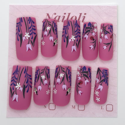 Magenta botanical nails on the pink Nailoli backing card