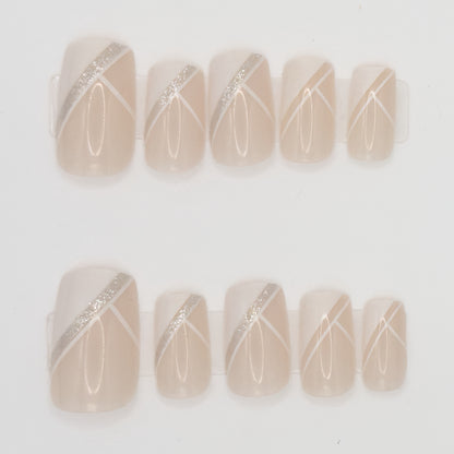 Set of beige nail art designs with silver and white lines on a light background