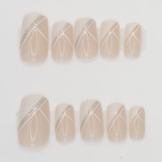 Set of beige nail art designs with silver and white lines on a light background
