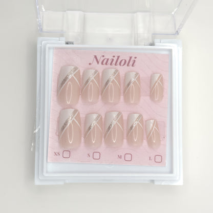 Nailoli nail art set with beige and gold designs in a clear plastic case.