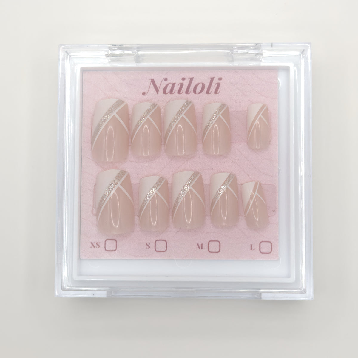 Set of nail designs in a clear case with 'Nailoli' branding on a light background
