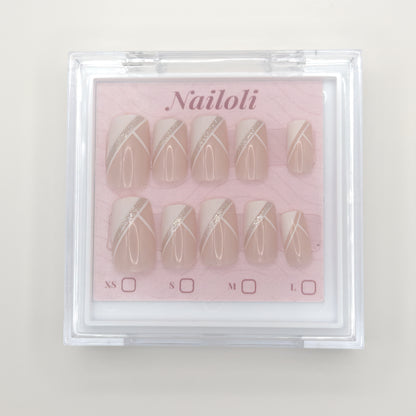 Set of nail designs in a clear case with 'Nailoli' branding on a light background
