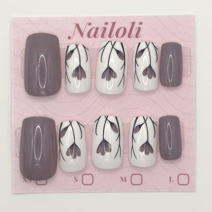 Taupe floral nails on the pink Nailoli backing card