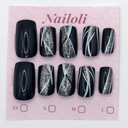 Glossy black nails on the pink Nailoli backing card with XS, S, M, and L size boxes