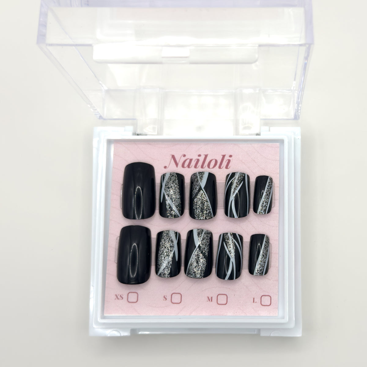 Glossy black set on its backing card inside the open clear Nailoli case