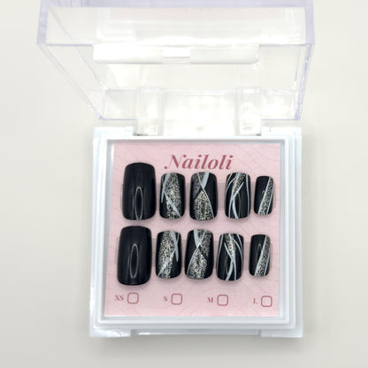 Glossy black set on its backing card inside the open clear Nailoli case
