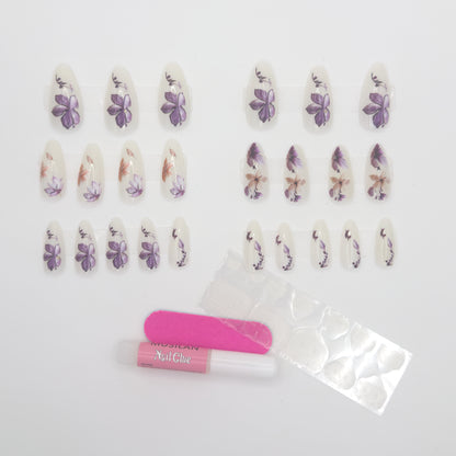 Full stiletto floral set laid out by size beside adhesive tabs
