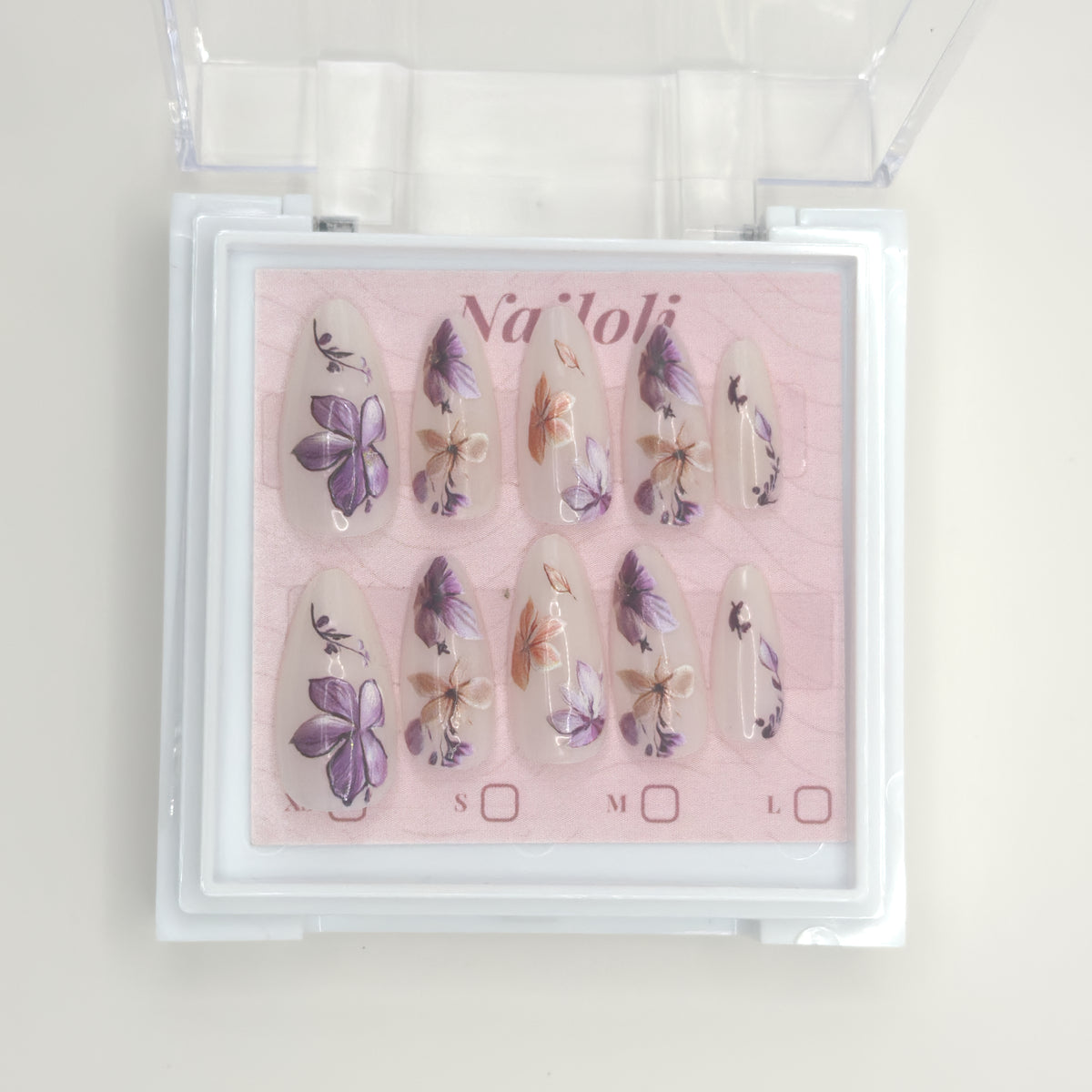Stiletto floral set on its backing card inside the open clear Nailoli case