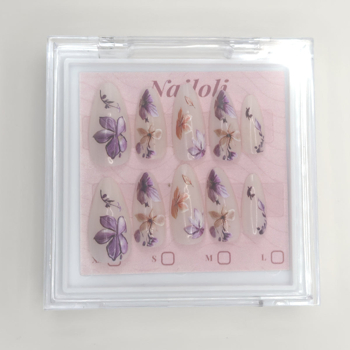Stiletto floral set inside the closed clear Nailoli case