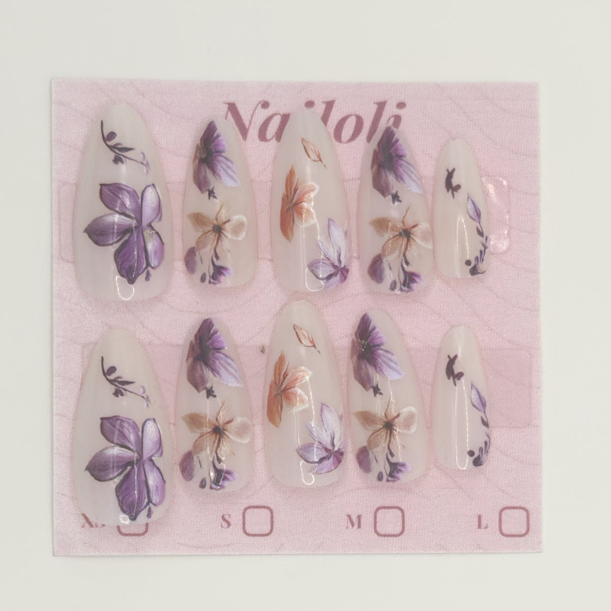 Stiletto floral nails on the pink Nailoli backing card