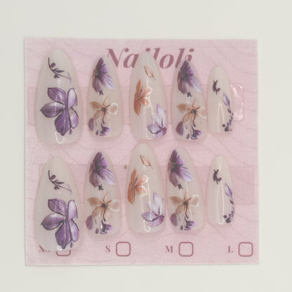 Stiletto floral nails on the pink Nailoli backing card
