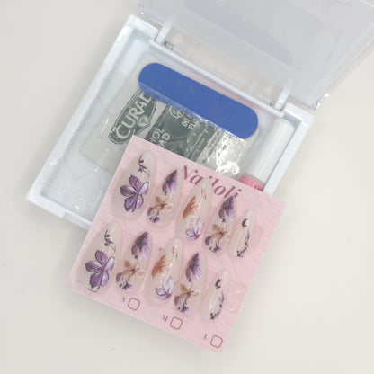 Stiletto floral set on its card beside the open kit with nail file, prep pad, and nail glue