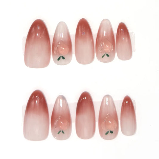 Ten medium almond press-ons in berry blush ombre, four with a 3D heart-shaped peach and green leaves