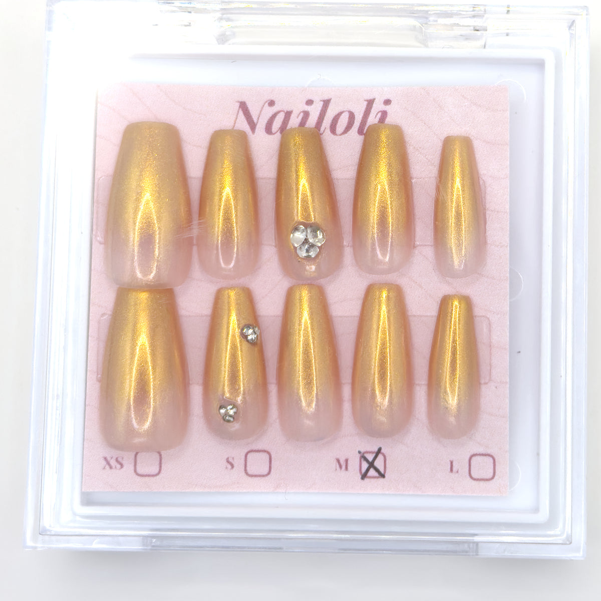 Champagne gold set on its backing card inside the open clear Nailoli case