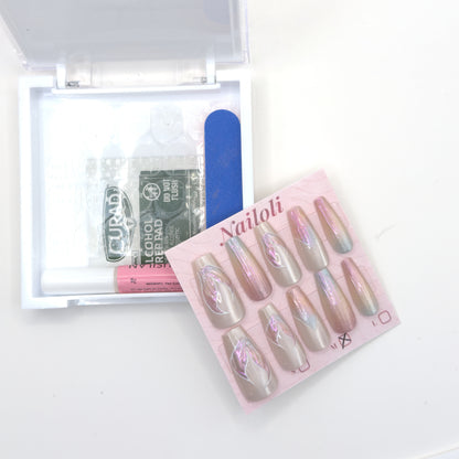 Pearl aurora set on its card beside the open kit with adhesive tabs, prep pad, glue, and nail file