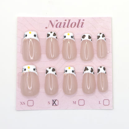 Cat and cowprint nails on the Nailoli backing card with size S marked