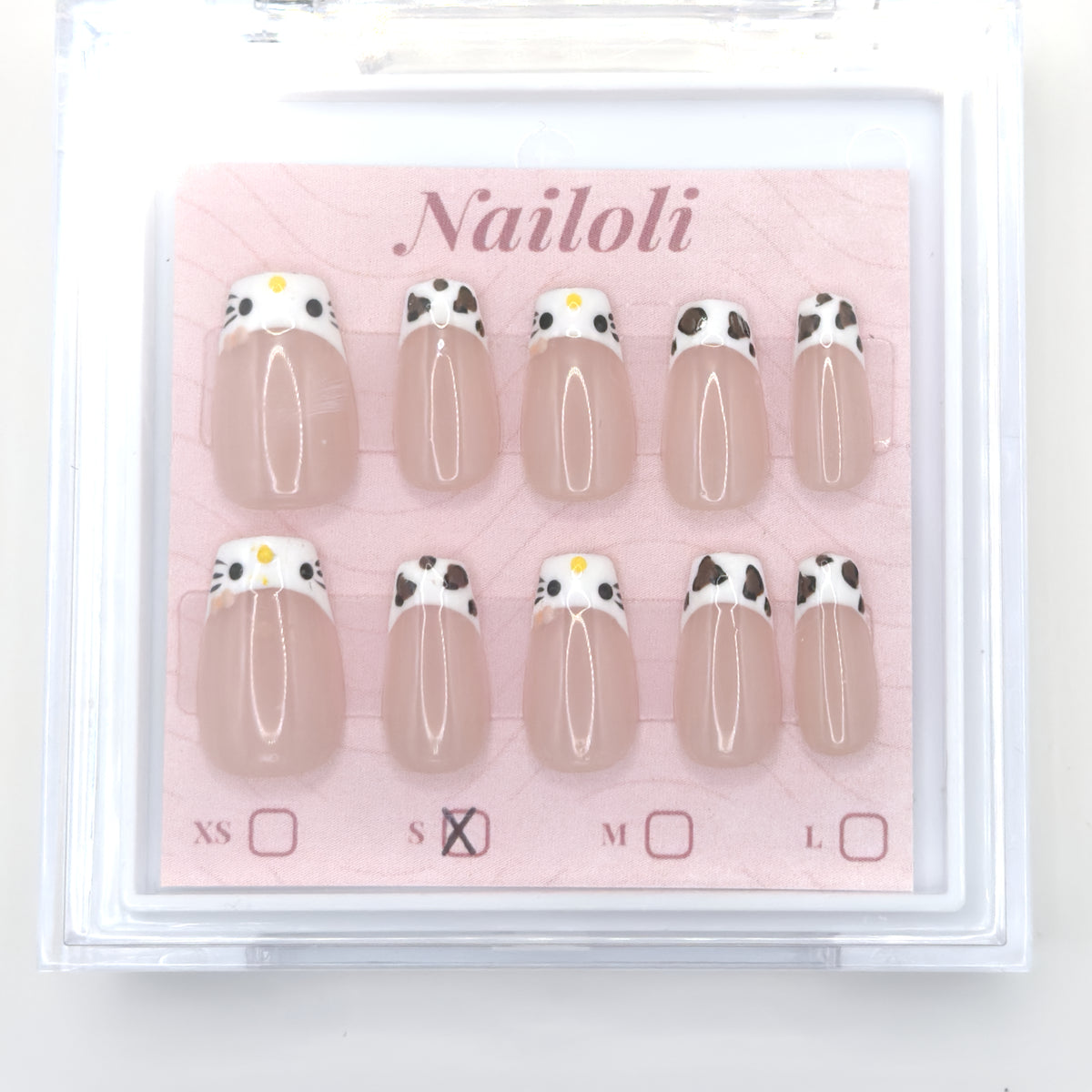 Cat and cowprint set on its backing card inside the open clear Nailoli case