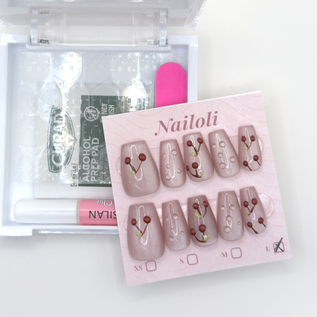 Cherry blush set on its card beside the open kit with glue, adhesive tabs, prep pad, and nail file