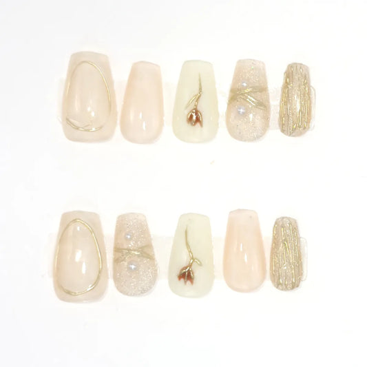 Ten short coffin press-ons in champagne nude, blush, cream and glitter with gold rose, gold wire and pearl accents