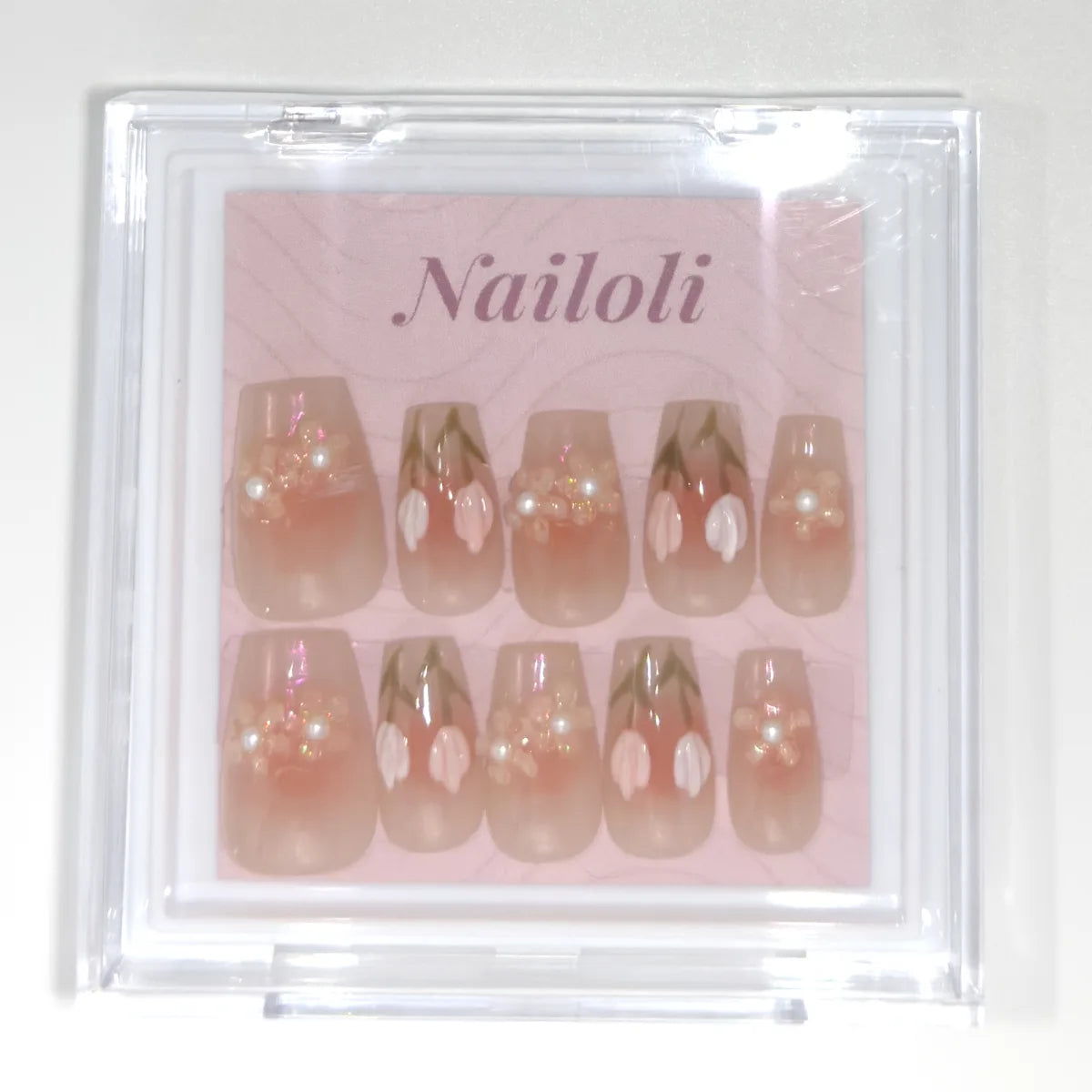 Sheer peach coffin set inside the closed clear Nailoli case