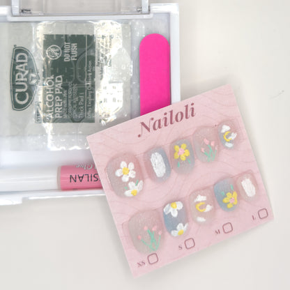 Daisy and tulip set on its card beside the open kit with nail glue, prep pad, and nail file