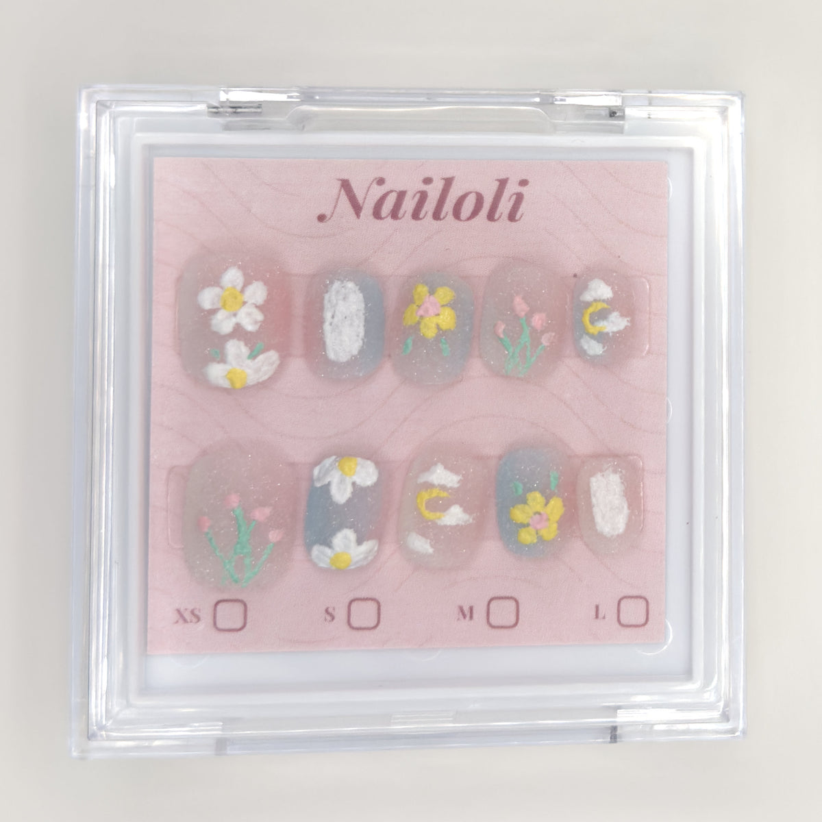 Daisy and tulip set inside the closed clear Nailoli case