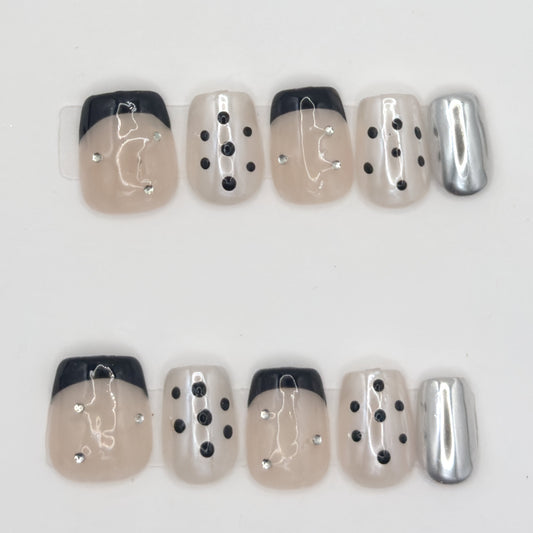 10 press-ons in two rows: black French tips, black dot nails, line art, gemstones, and silver chrome
