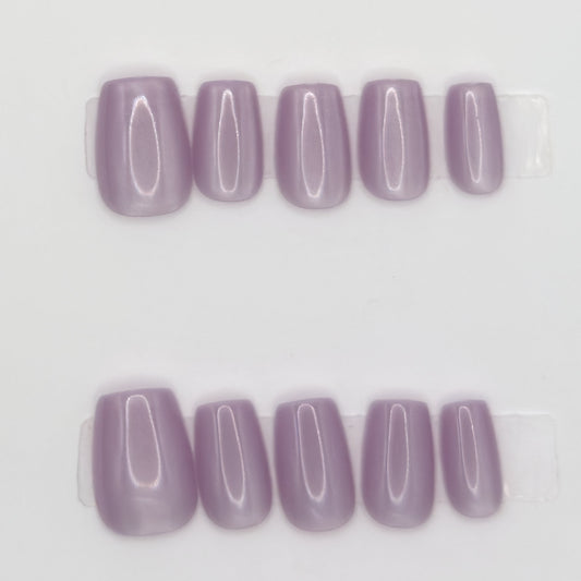 Close-up of 10 lavender square press-ons in two rows showing the glossy finish