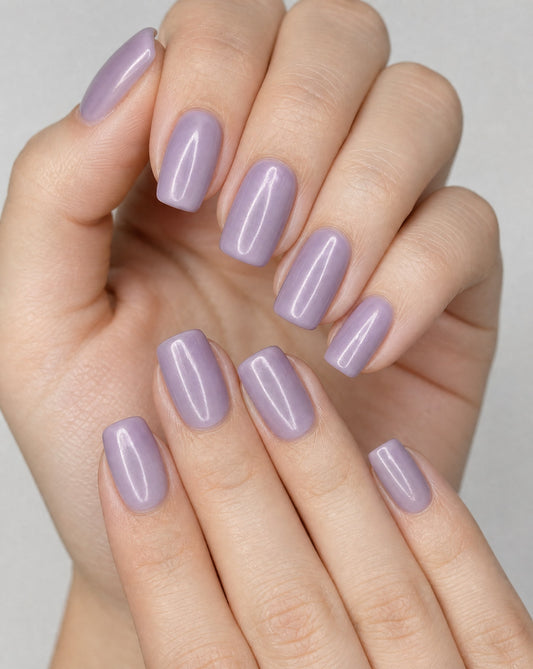 Hands wearing glossy lavender square press-on nails