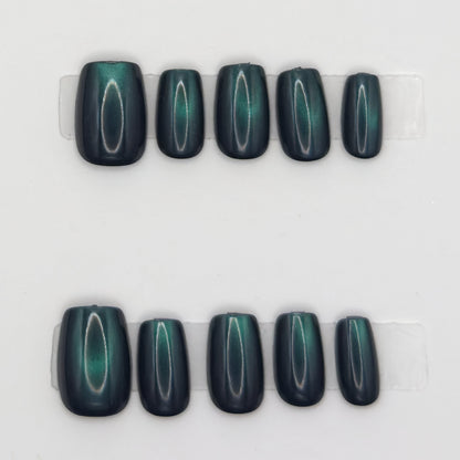 10 emerald cat eye square press-ons in two rows showing the green light band on each nail